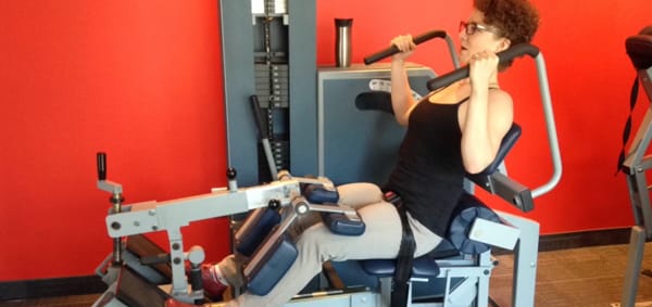 Woman working out on exercise equipment at OneUp in Halifax.