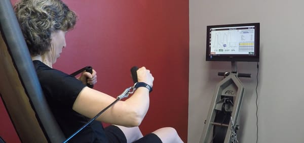 Woman working out on exercise equipment at OneUp in Halifax.